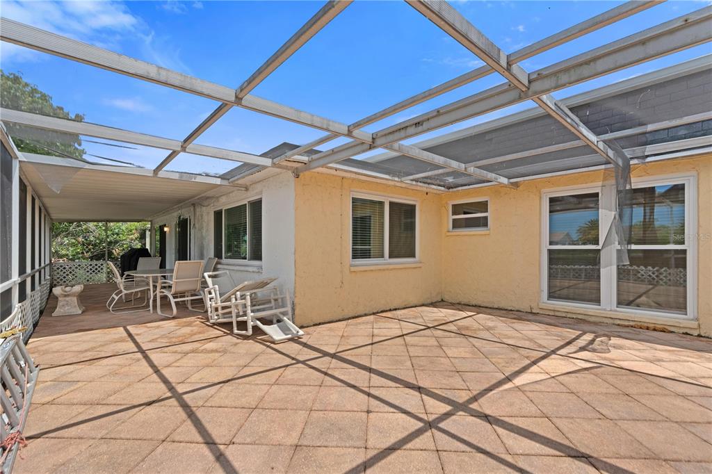 A screened-in patio with a tiled floor and a metal frame roof — 3531 LANDALE DRIVE, HOLIDAY, FL