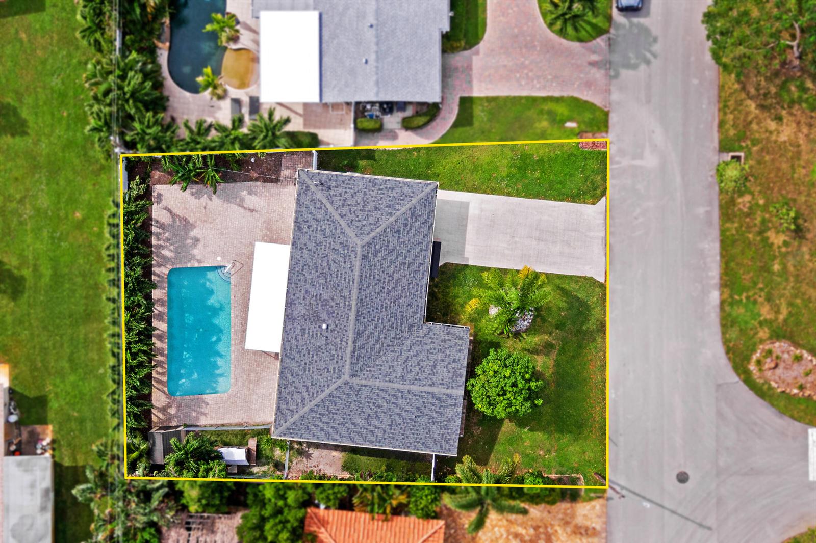 An aerial view shows a house with a shingled roof, pool, and driveway on a lot — 912 SE 8th Court, Deerfield Beach FL 33441, DEERFIELD BEACH, FL