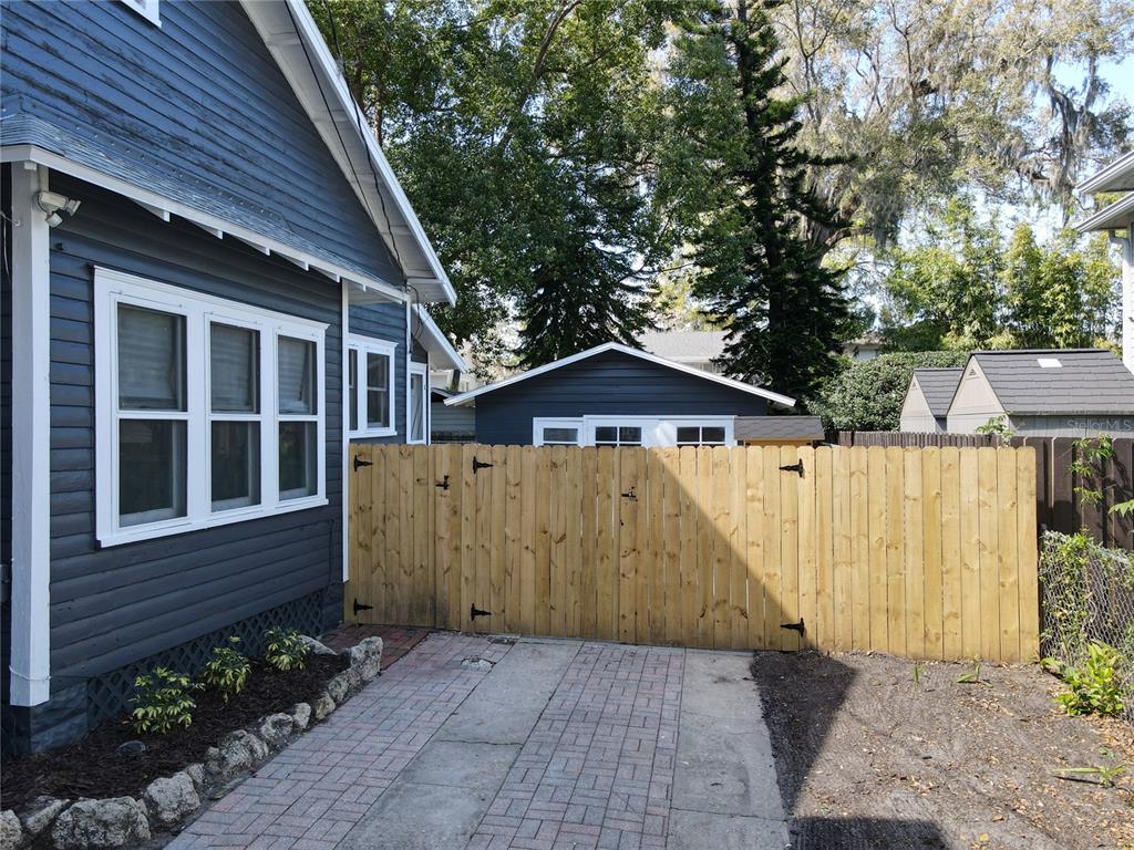 A blue house exterior with a wooden fence and a brick driveway — 16 N LAWSONA BOULEVARD, ORLANDO, FL