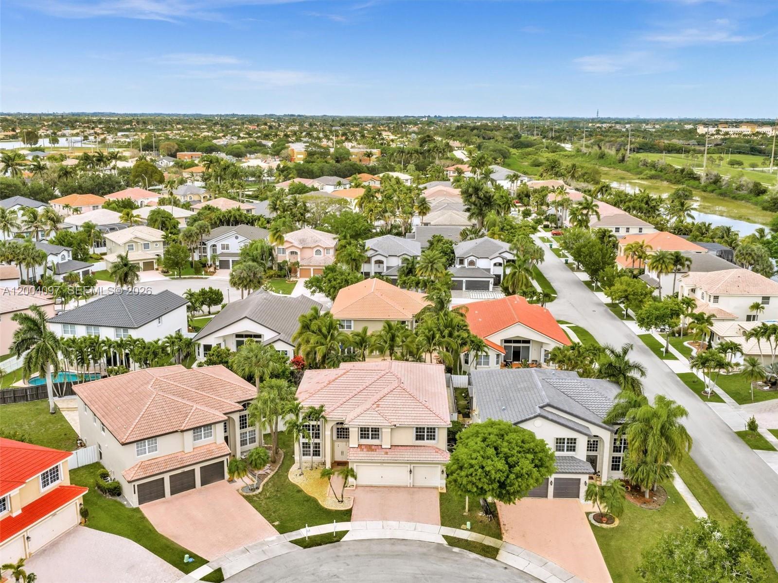 An aerial view shows a suburban neighborhood with houses, palm trees, and a cul-de-sac — 17351 SW 32nd Ct, Miramar FL 33029, MIRAMAR, FL