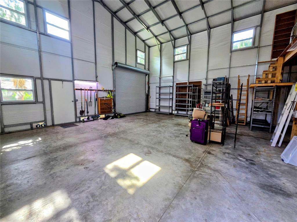 A two-story building with two open garage bays on the ground floor and two windows above — 6504 WERNER AVENUE, NEW PORT RICHEY, FL