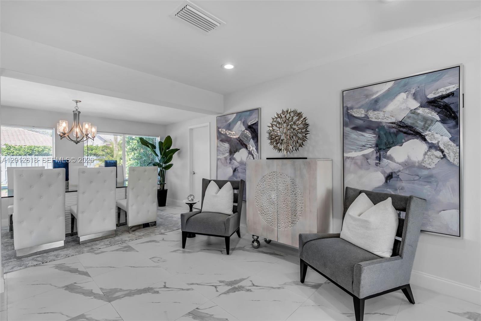 A dining area features a glass table, white tufted chairs, and two gray accent chairs — 465 NW 11th St, Boca Raton FL 33432, BOCA RATON, FL