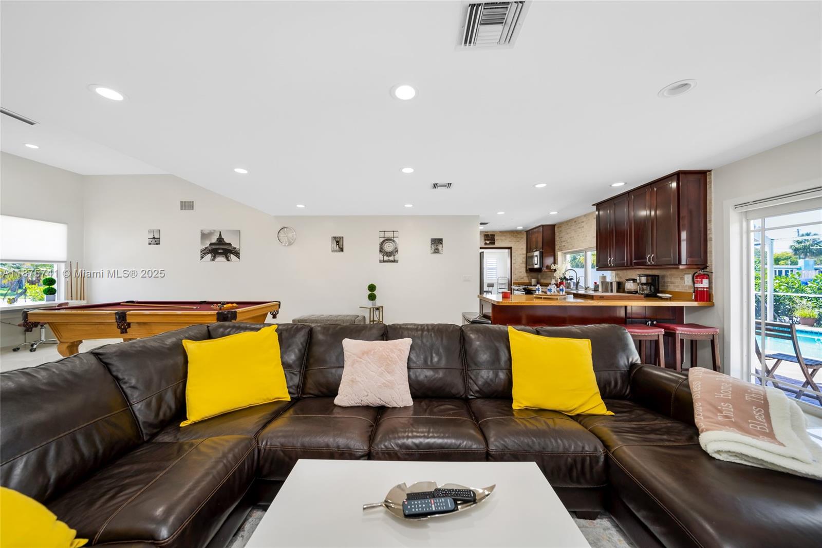 A living room with a brown leather sectional, pool table, and an open kitchen area — 31 SE 12th St, Pompano Beach FL 33060, POMPANO BEACH, FL