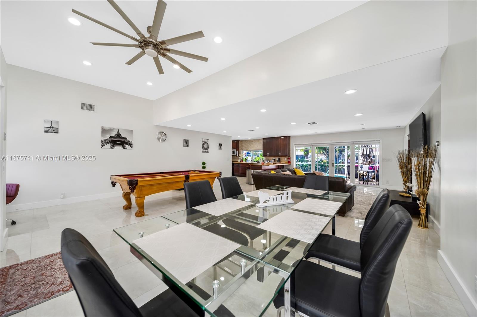 A spacious open-concept room features a glass dining table, a pool table, and a kitchen — 31 SE 12th St, Pompano Beach FL 33060, POMPANO BEACH, FL