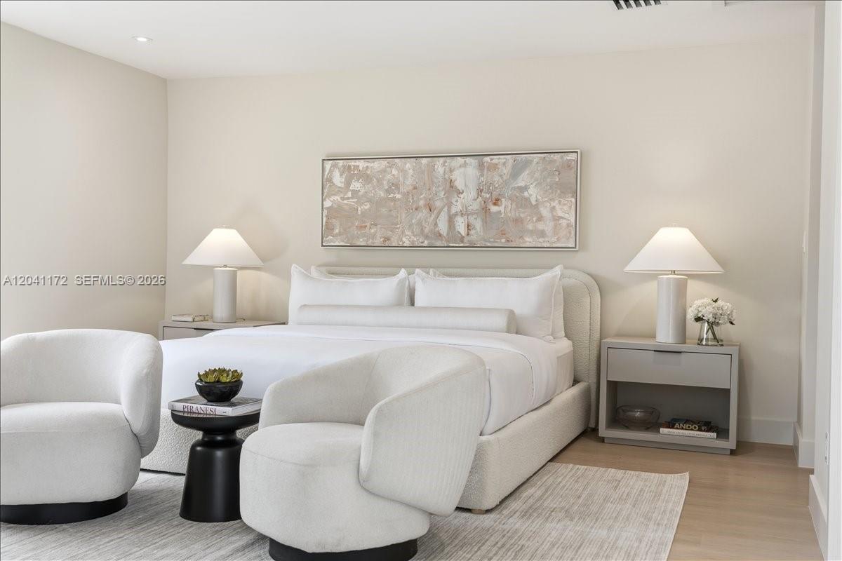 A modern bedroom features a white upholstered bed, two armchairs, and matching bedside lamps — 6250 SW 48th St, Miami FL 33155, MIAMI, FL