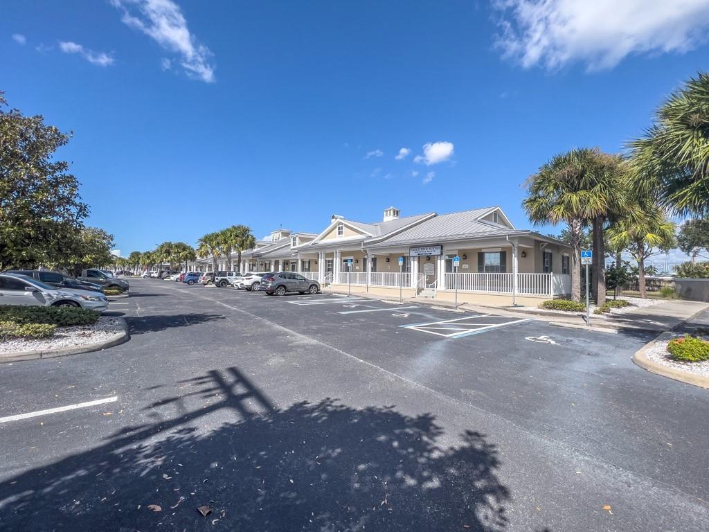 A single-story commercial office building with a metal roof and parking lot in front — 411 APOLLO BEACH BOULEVARD UNIT 900, APOLLO BEACH, FL