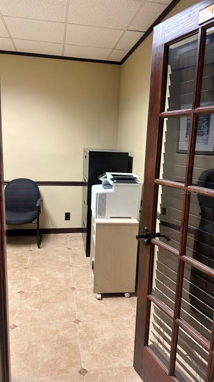 A small office room features a black chair, a printer on a cart, and tile flooring — 411 APOLLO BEACH BOULEVARD UNIT 900, APOLLO BEACH, FL