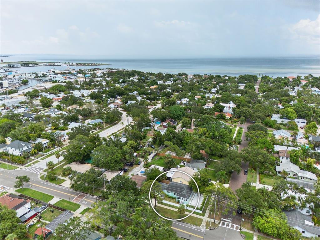 An aerial view shows a light-colored house circled in a residential neighborhood near the coast — 1846 3RD STREET S, ST PETERSBURG, FL