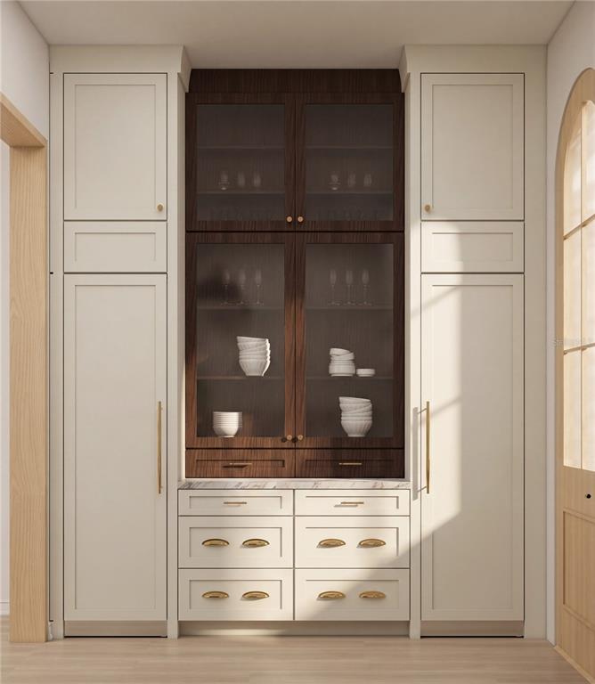 This rendering shows a kitchen wall featuring cream-colored cabinetry flanking a central dark wood hutch — 1627 MIZELL AVENUE, WINTER PARK, FL