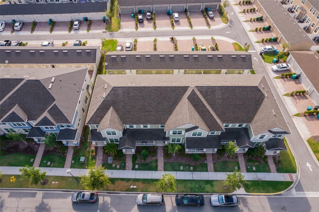 A two-story townhouse exterior features a covered front porch, dark shutters, and a paved walkway — 8515 VEDDER LN, ORLANDO, FL