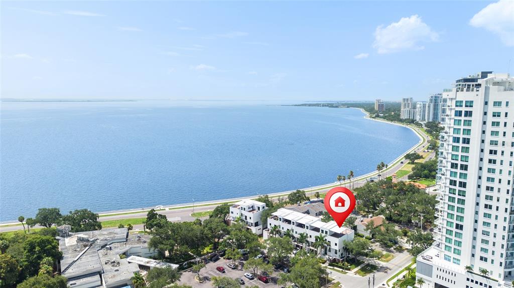 An aerial view shows a multi-story residential building near a large body of water — 2814 W BARCELONA STREET, TAMPA, FL