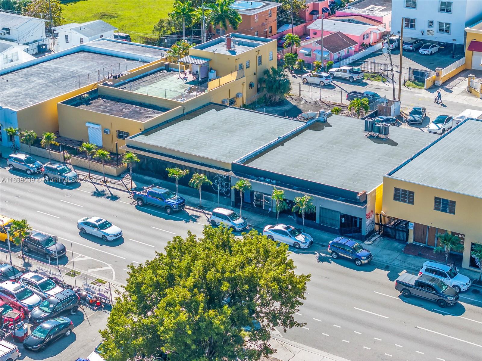 An aerial view shows a commercial building with a flat roof next to a street — 1544 W Flagler St, Miami FL 33135, MIAMI, FL