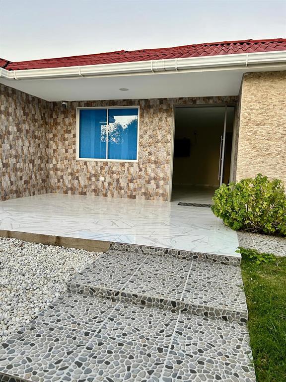 A house exterior featuring a stone-tiled facade, a covered porch, and a pebble-tiled entryway — Cra 11 #7-72, SANTA VERONICA, ATLANTICO, OC