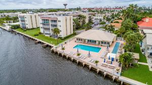 An aerial view shows a waterfront apartment complex with a swimming pool and patio area — 646 Snug Harbor Drive # H308, Boynton Beach FL 33435, BOYNTON BEACH, FL