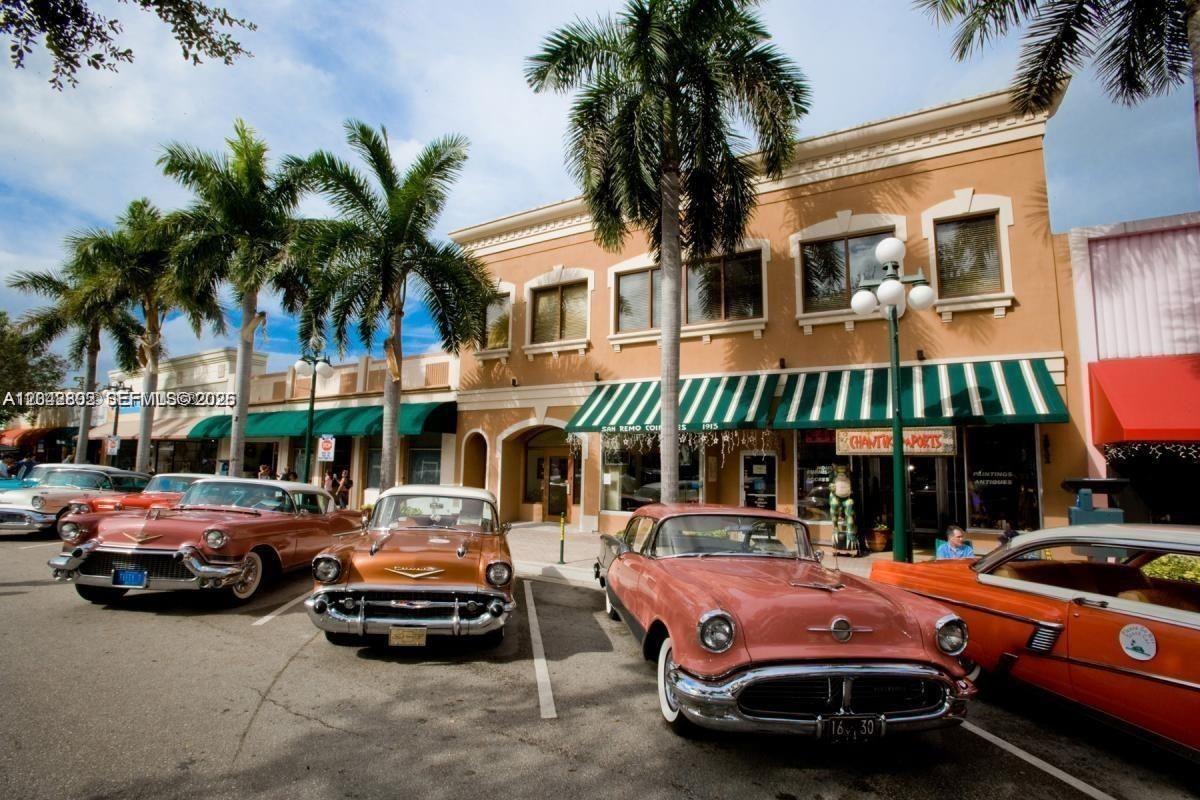 A tan commercial building with green awnings and several vintage cars parked in front — 2126 Arthur St # 1, Hollywood FL 33020, HOLLYWOOD, FL