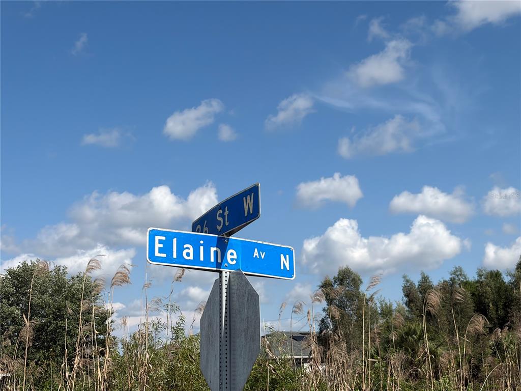 A cleared, muddy residential lot sits in front of a house under a blue sky — 2619 26TH STREET W, LEHIGH ACRES, FL