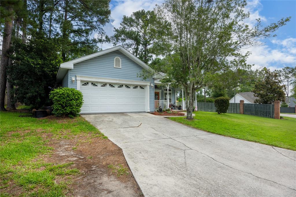 A light blue house with a two-car garage and a concrete driveway — 11516 NW 16TH PLACE, GAINESVILLE, FL