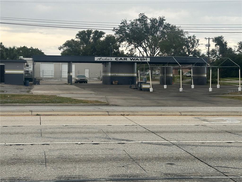 An exterior view of a car wash facility with a covered service area and parking — 1605 W MEMORIAL BOULEVARD, LAKELAND, FL