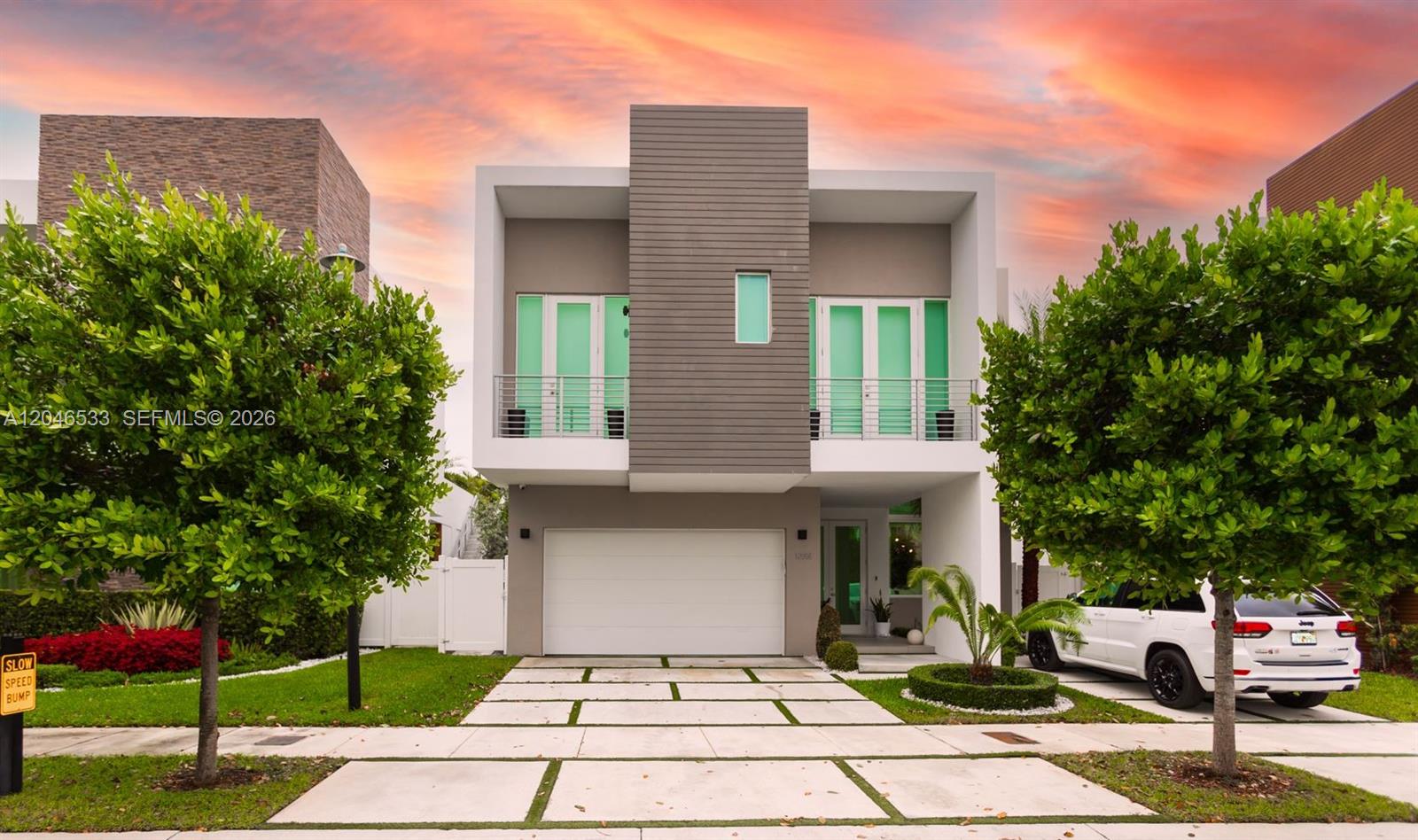 A modern two-story house with a white frame, gray accents, and a paved driveway — 10561 NW 68th Ter, Doral FL 33178, DORAL, FL