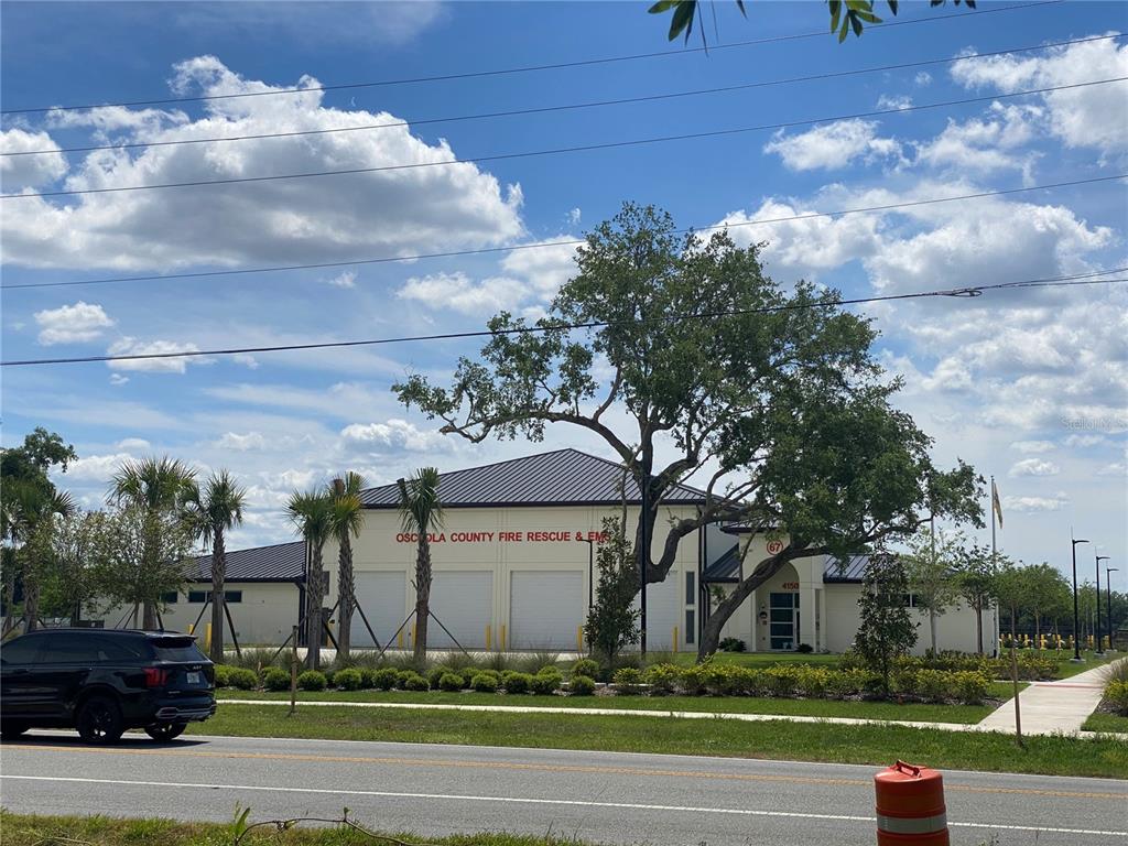 A view of an Osceola County Fire Rescue and EMS station with a large tree — 4210 CARDINAL LANE, KISSIMMEE, FL