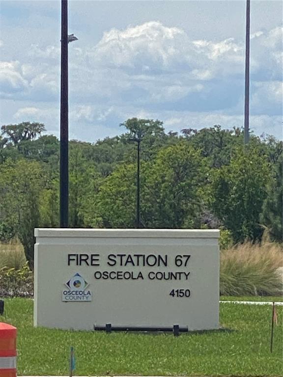A sign for Osceola County Fire Station 67 stands in a grassy area outdoors — 4210 CARDINAL LANE, KISSIMMEE, FL