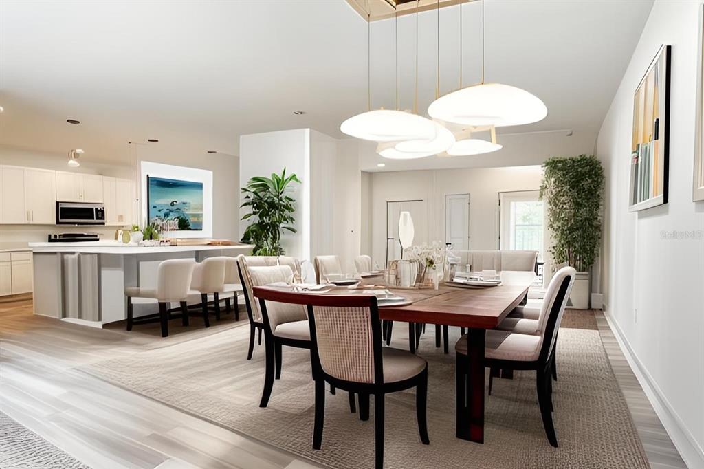 A dining room with a wooden table and chairs sits adjacent to a white kitchen — 2165 MUSIC LANE, NORTH PORT, FL