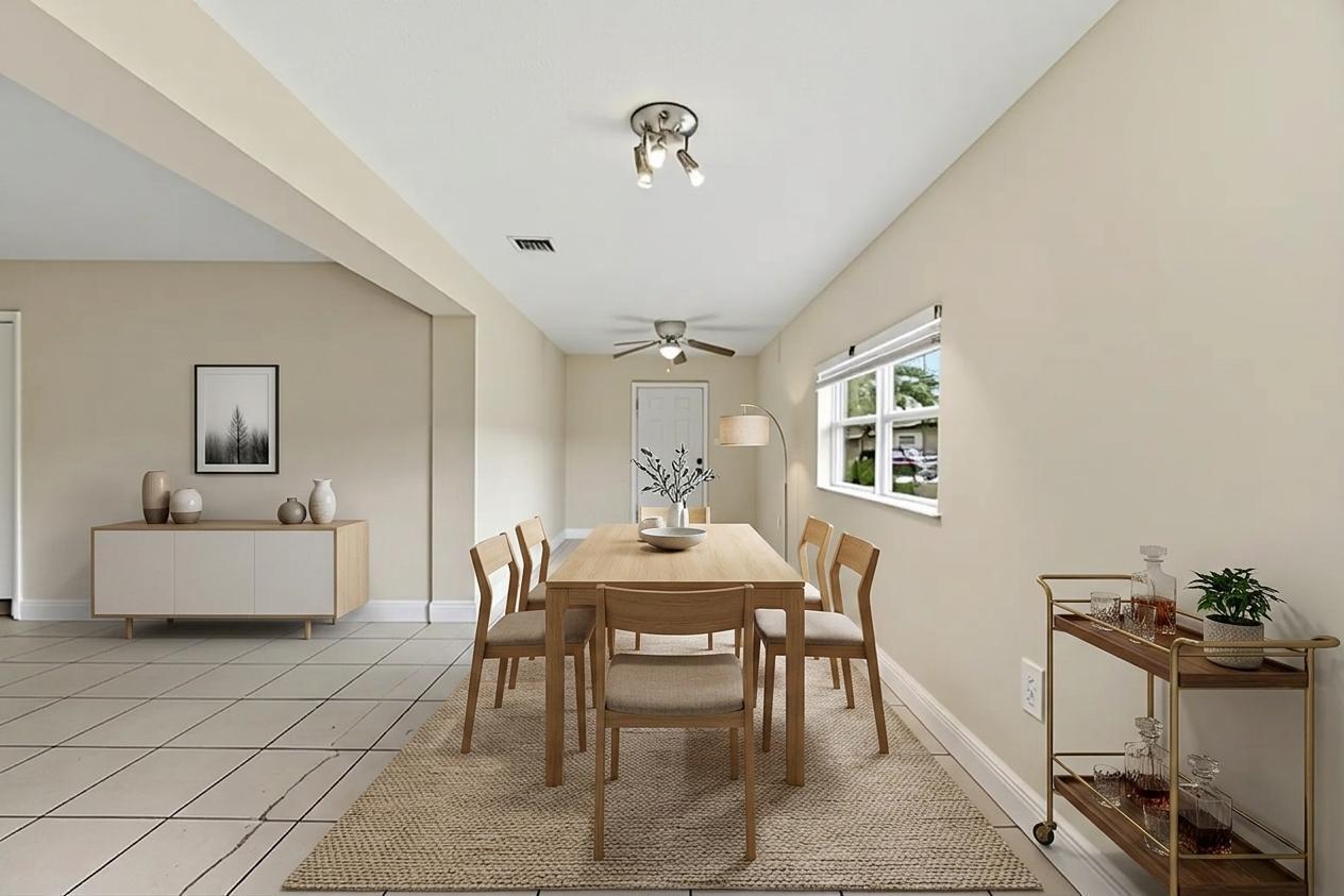 A dining room with a wooden table, six chairs, a sideboard, and a bar cart — 5131 SW 6th Street, Margate FL 33068, MARGATE, FL