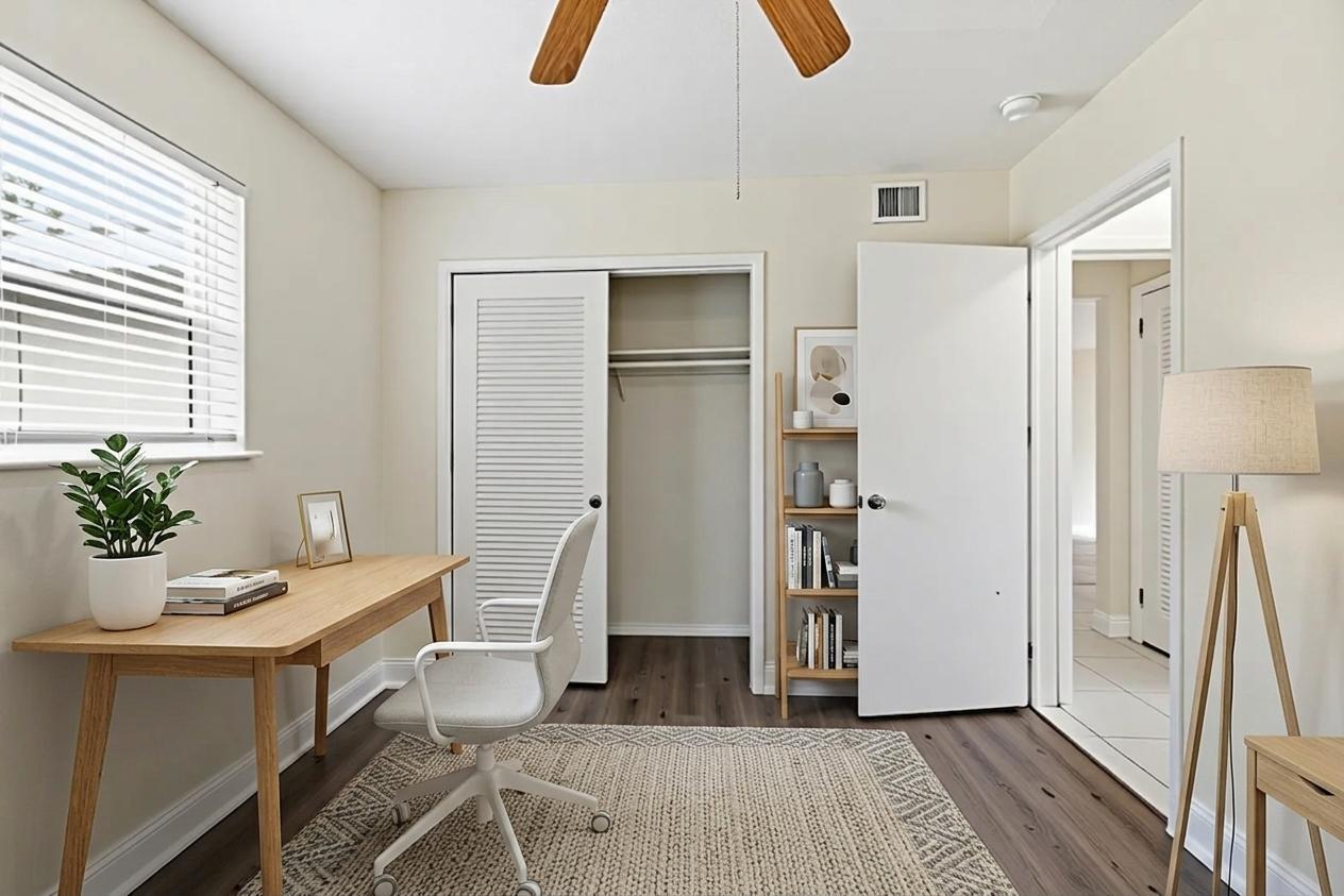 A home office featuring a wooden desk, a white rolling chair, and a closet — 5131 SW 6th Street, Margate FL 33068, MARGATE, FL