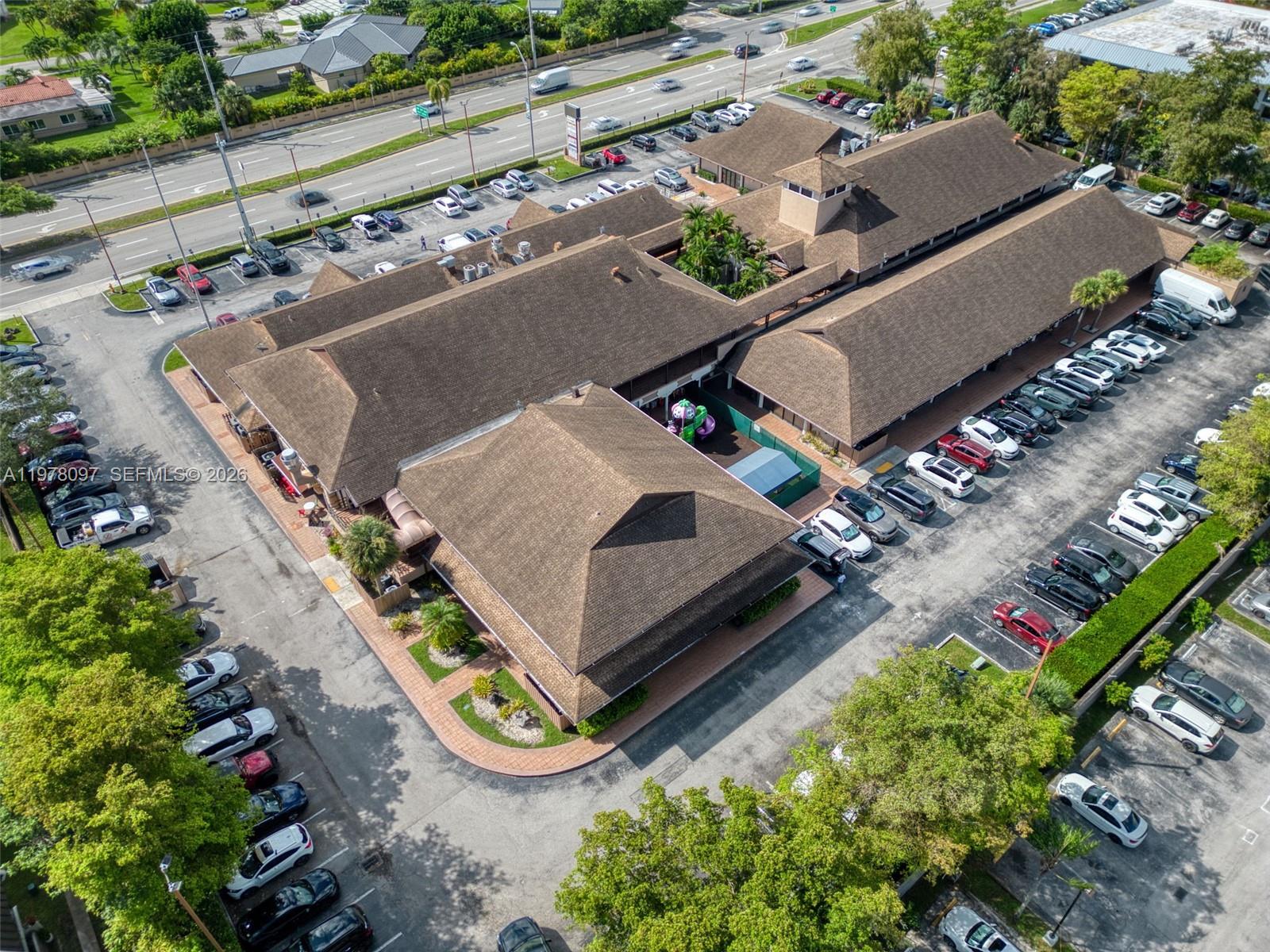 An aerial view shows a commercial building with a brown roof and surrounding parking lots — 10471 SW 88th St, Miami FL 33176, MIAMI, FL