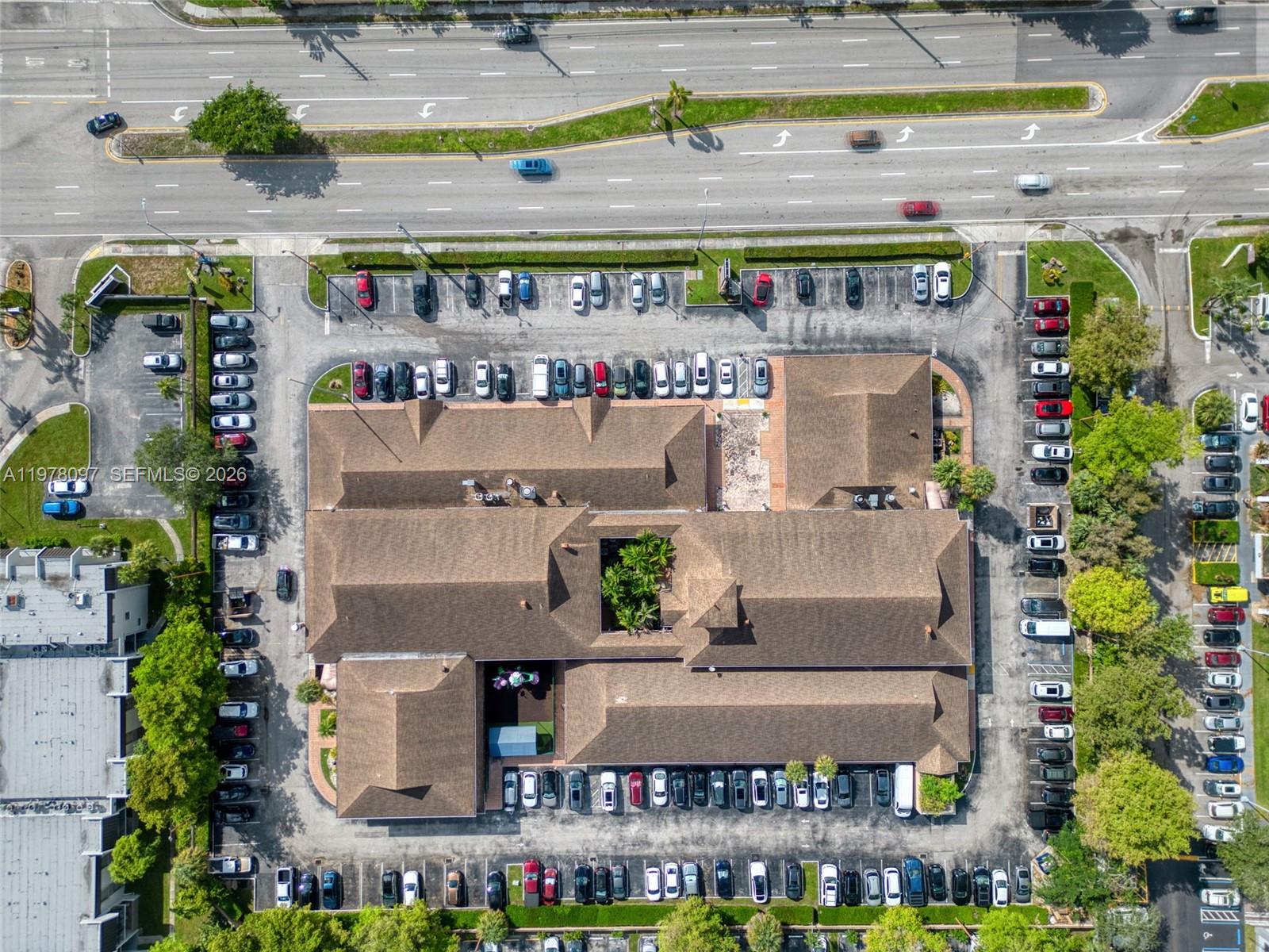 An aerial view shows a commercial building with a central courtyard surrounded by parking lots — 10471 SW 88th St, Miami FL 33176, MIAMI, FL