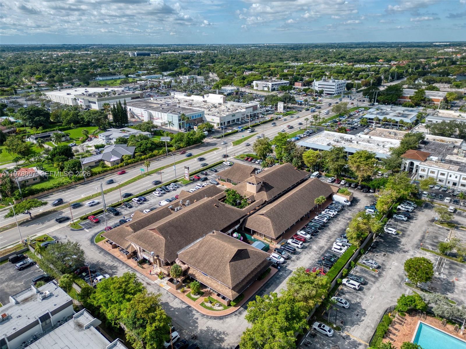 An aerial view shows a commercial building with a brown roof and surrounding parking lots — 10471 SW 88th St, Miami FL 33176, MIAMI, FL