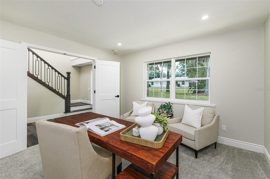 A two-story brick house with three dormer windows sits on a large, grassy lot — 3415 IMPERIAL LANE, LAKELAND, FL