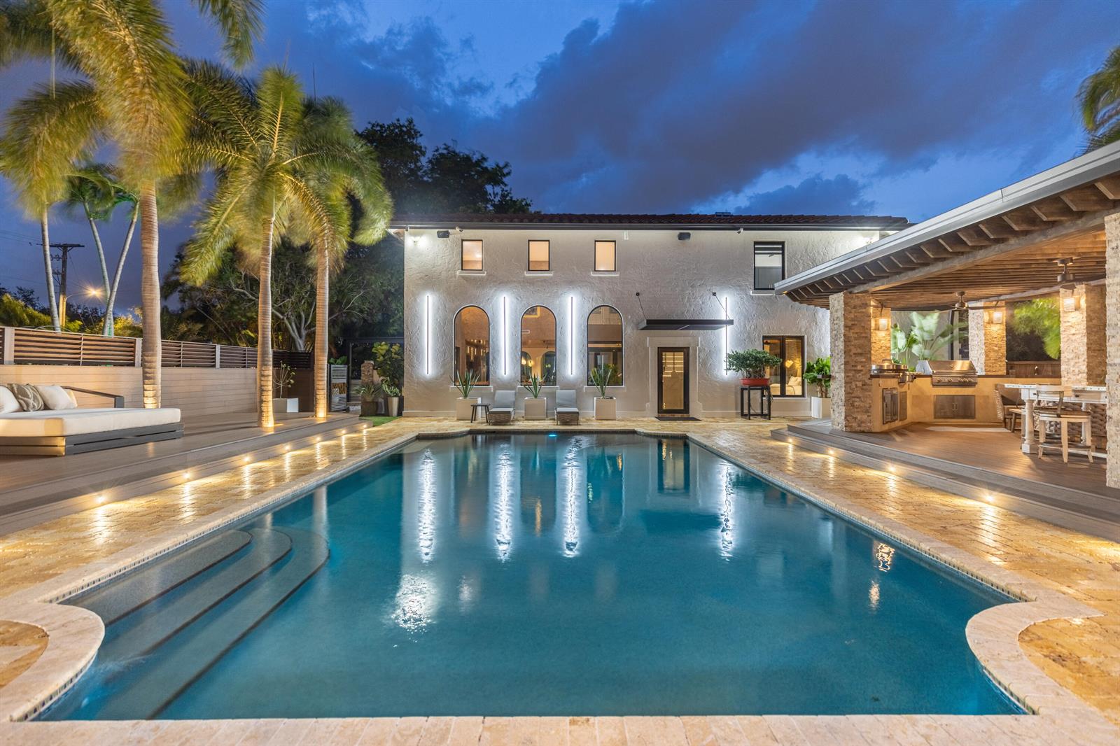 A backyard features a swimming pool, a covered patio with a kitchen, and a two-story house — 290 NW 6th Street, Boca Raton FL 33432, BOCA RATON, FL