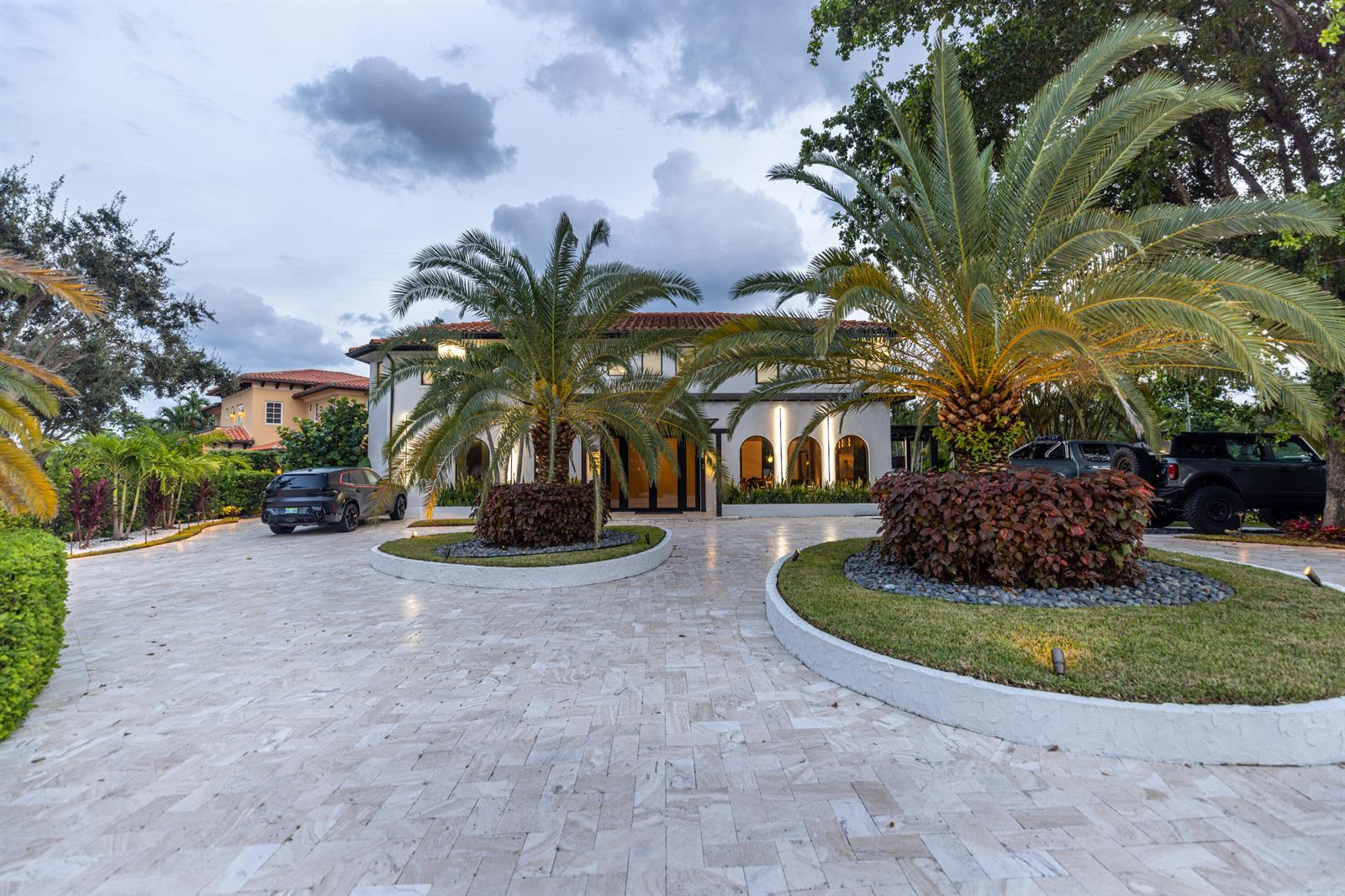 A two-story house with a circular driveway, palm trees, and two parked vehicles — 290 NW 6th Street, Boca Raton FL 33432, BOCA RATON, FL