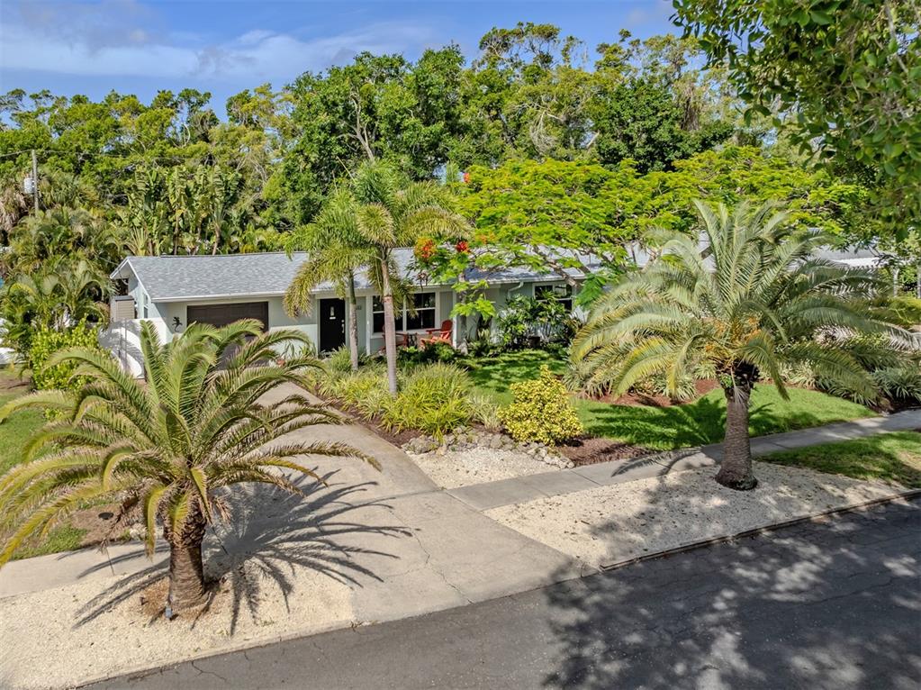A single-story house with a gray roof, palm trees, and a concrete driveway — 632 PARK DRIVE, BRADENTON, FL