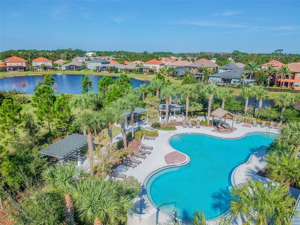 An aerial view shows a community swimming pool with lounge chairs and a pergola — 13170 GREEN VIOLET DRIVE, RIVERVIEW, FL