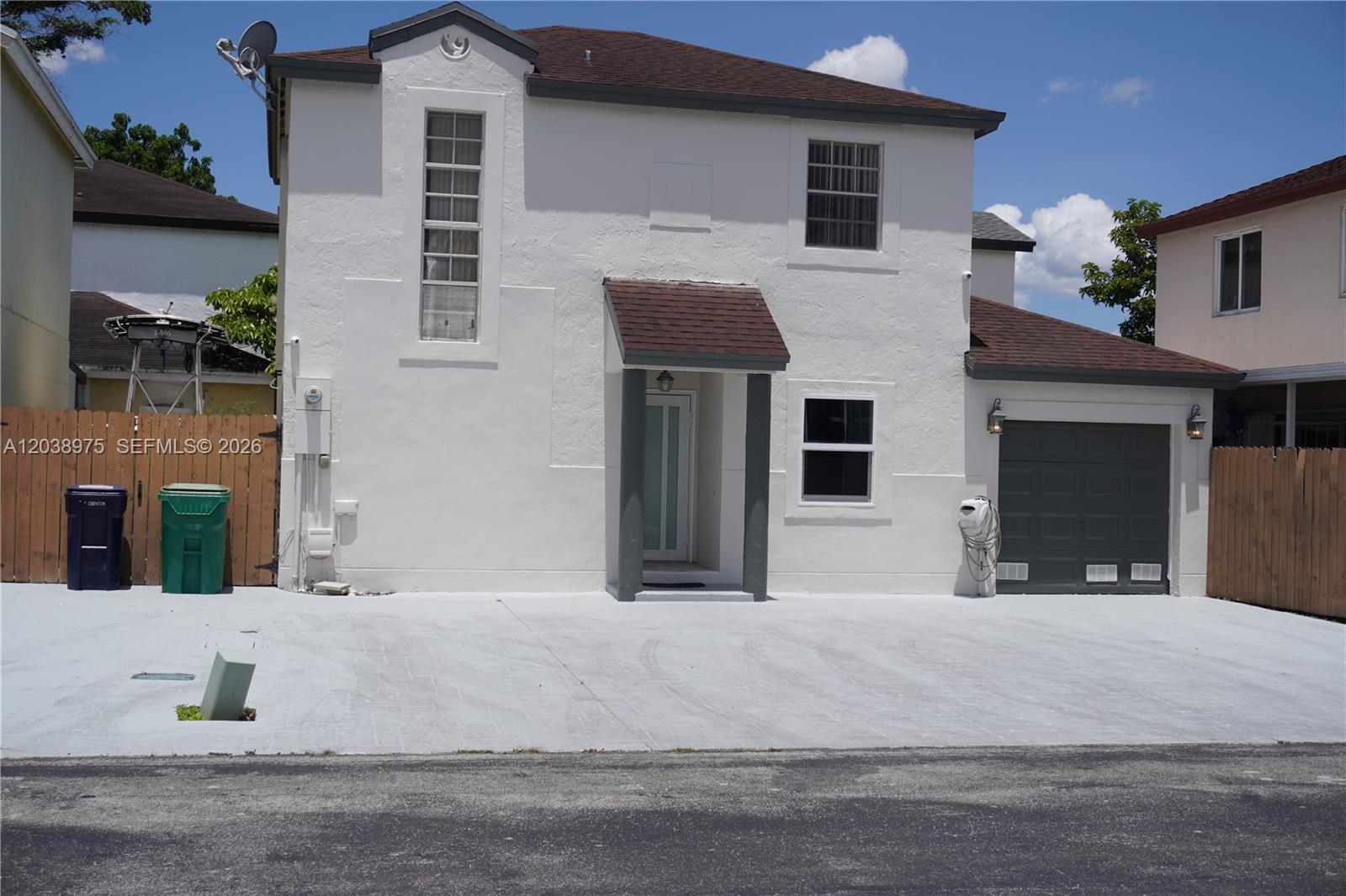 A two-story white house with a brown roof, a garage, and a concrete driveway — 9132 SW 148th Ct # 0, Miami FL 33196, MIAMI, FL