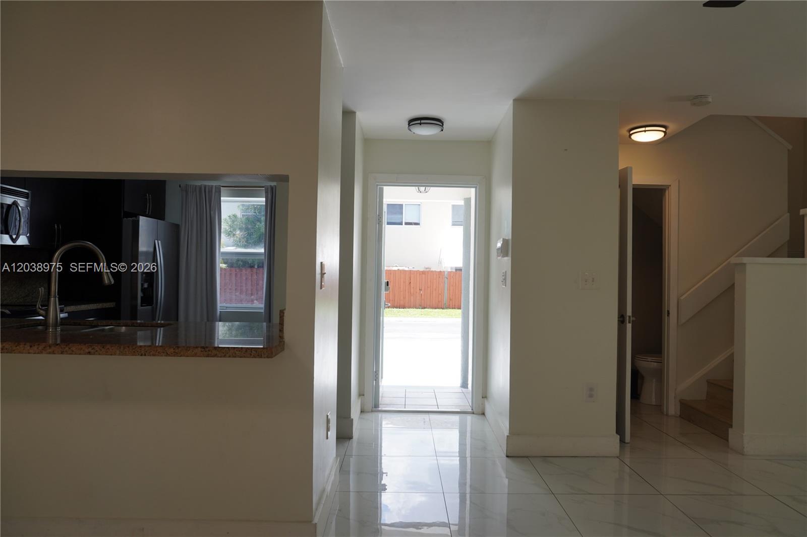 A view from inside a home looking toward an open front door with tiled floors — 9132 SW 148th Ct # 0, Miami FL 33196, MIAMI, FL