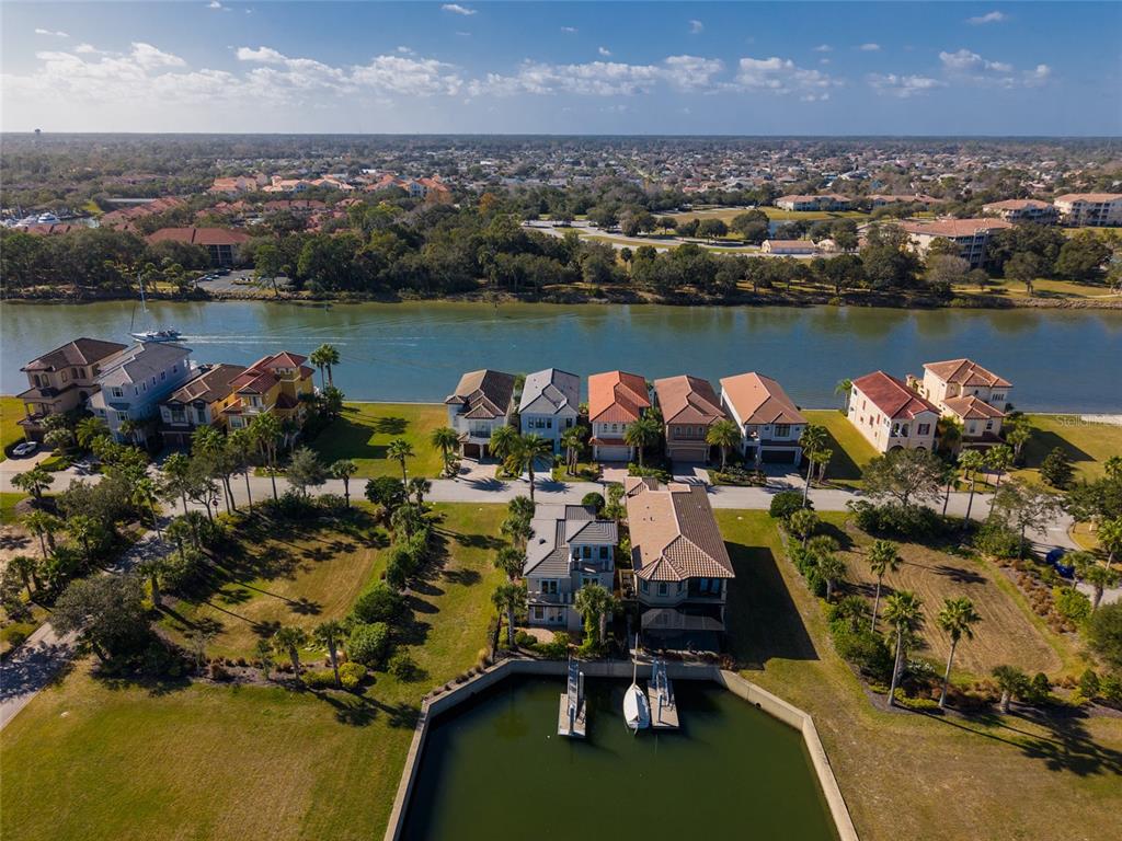 An aerial view shows waterfront homes with private boat slips along a canal — 259 YACHT HARBOR DRIVE, PALM COAST, FL