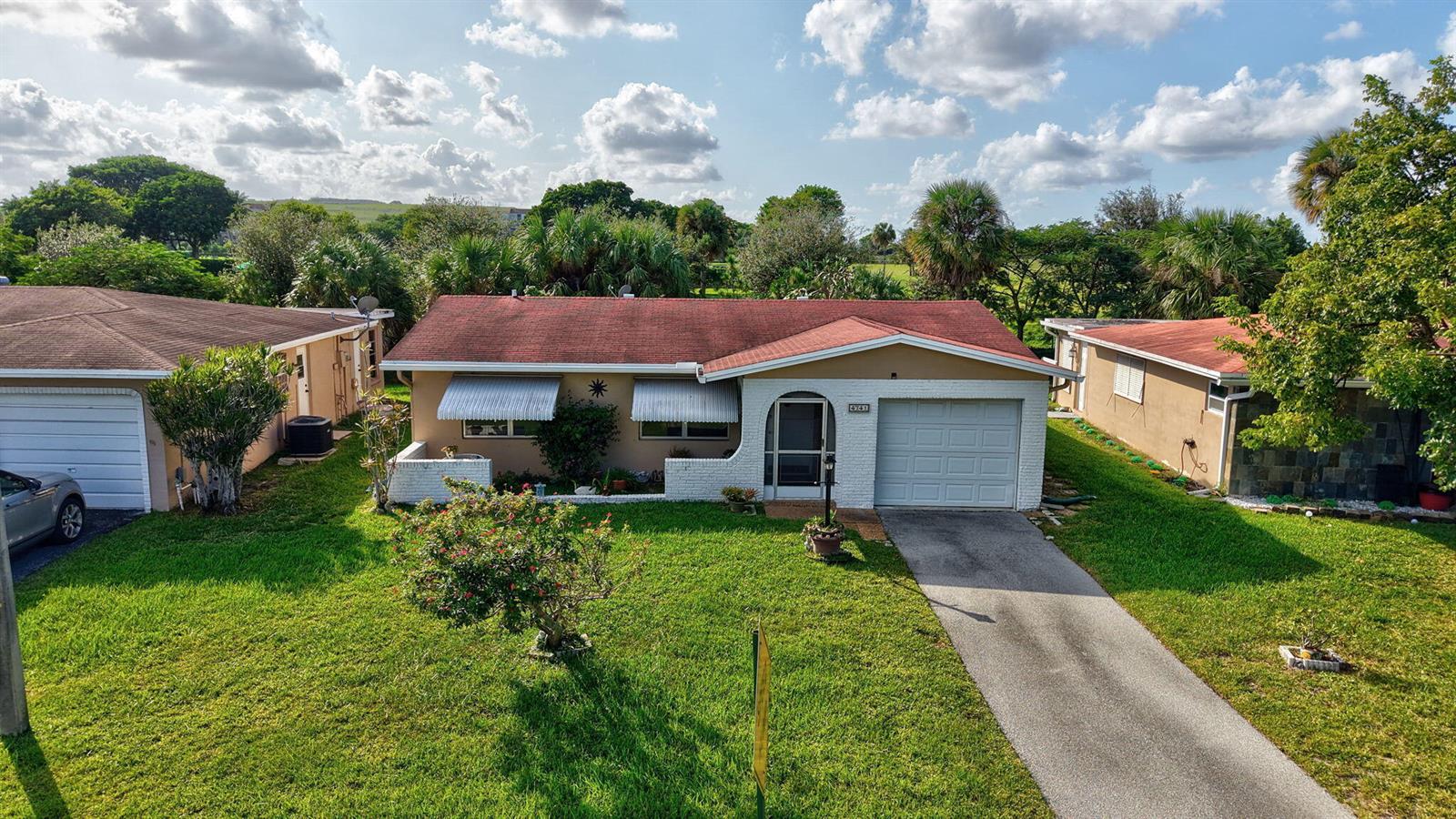 A single-story house with a red roof, white brick accents, and a concrete driveway — 4741 NW 13th Avenue, Deerfield Beach FL 33064, DEERFIELD BEACH, FL