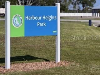 A sign for Harbour Heights Park stands on a grassy lawn — 2993 SEAFARER DRIVE, PUNTA GORDA, FL