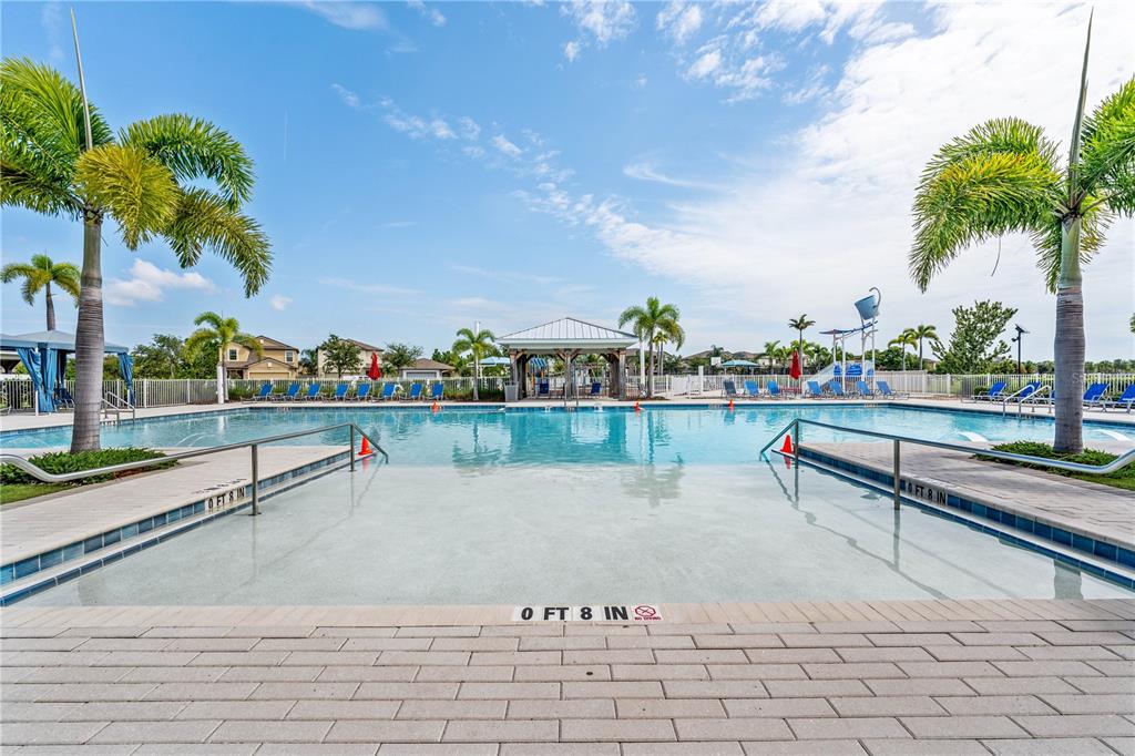 An aerial view shows a community clubhouse with a pool, playground, and sports courts — 7235 SALT RIVER AVENUE, SUN CITY CENTER, FL