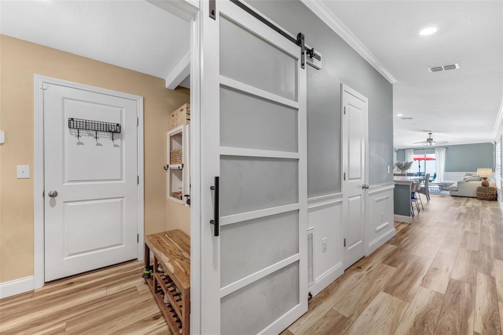 A kitchen features dark wood cabinets, a white marble island, and stainless steel appliances — 7235 SALT RIVER AVENUE, SUN CITY CENTER, FL