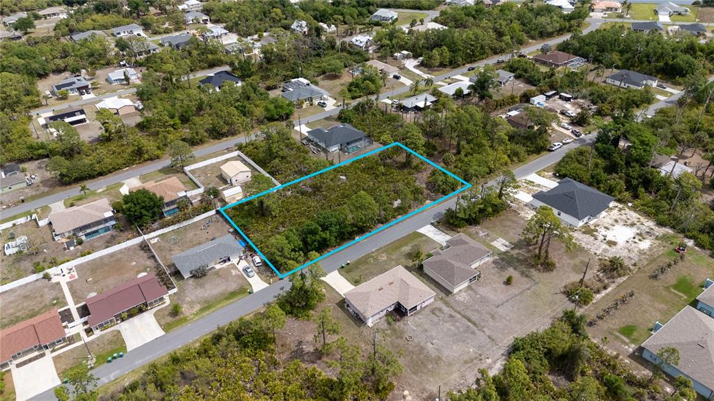An aerial view shows a vacant, rectangular residential lot outlined in blue between two roads — 11306 KIMBERLY AVENUE, ENGLEWOOD, FL