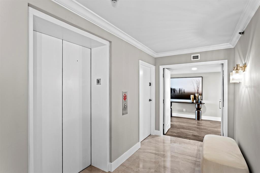 An elevator lobby features white doors, a marble floor, and an entrance to a room — 3301 BAYSHORE BOULEVARD UNIT 806C, TAMPA, FL