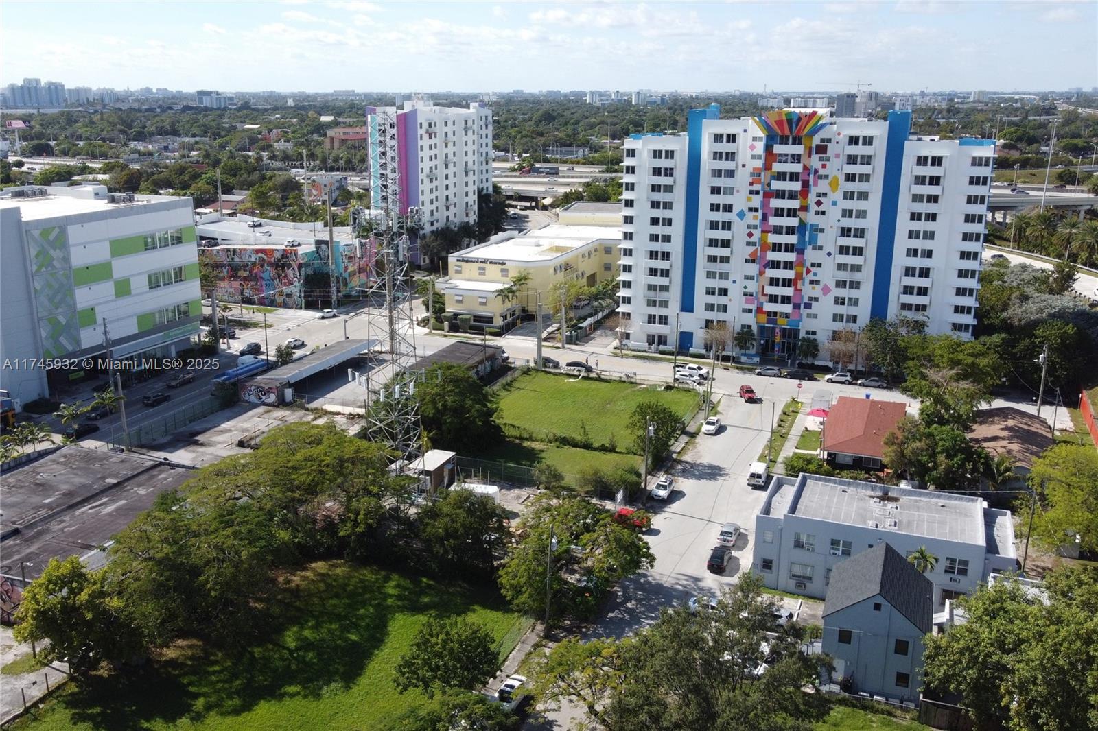 An aerial view shows urban buildings, a vacant lot, and a tall communication tower — 321 NW 37th St, Miami FL 33127, MIAMI, FL