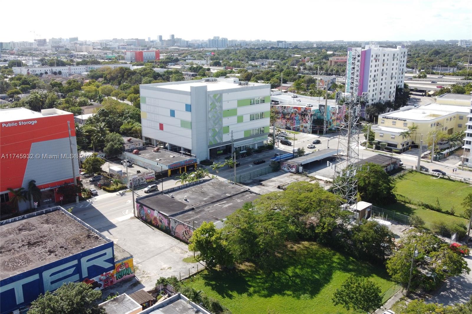 An aerial view shows a city street with commercial buildings, storage facilities, and green space — 321 NW 37th St, Miami FL 33127, MIAMI, FL