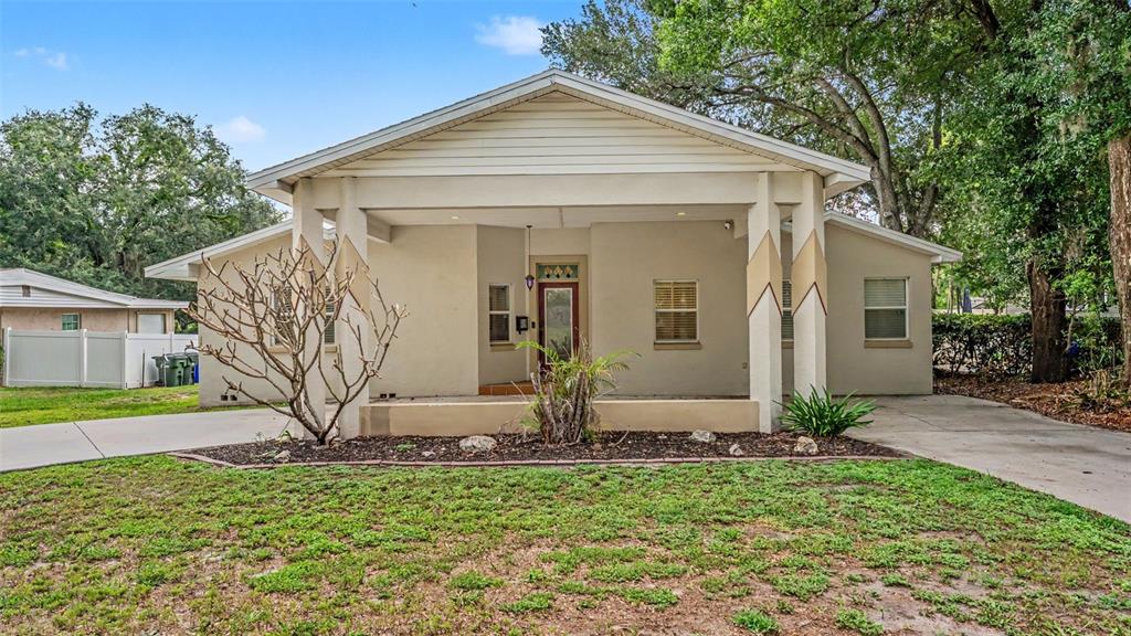 A single-story house with a large covered front porch and a concrete driveway — 926 HOLLINGSWORTH ROAD, LAKELAND, FL
