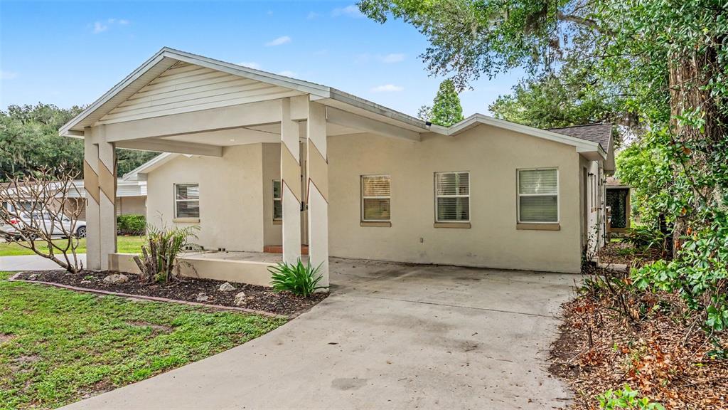A single-story house with a large covered carport and a concrete driveway — 926 HOLLINGSWORTH ROAD, LAKELAND, FL