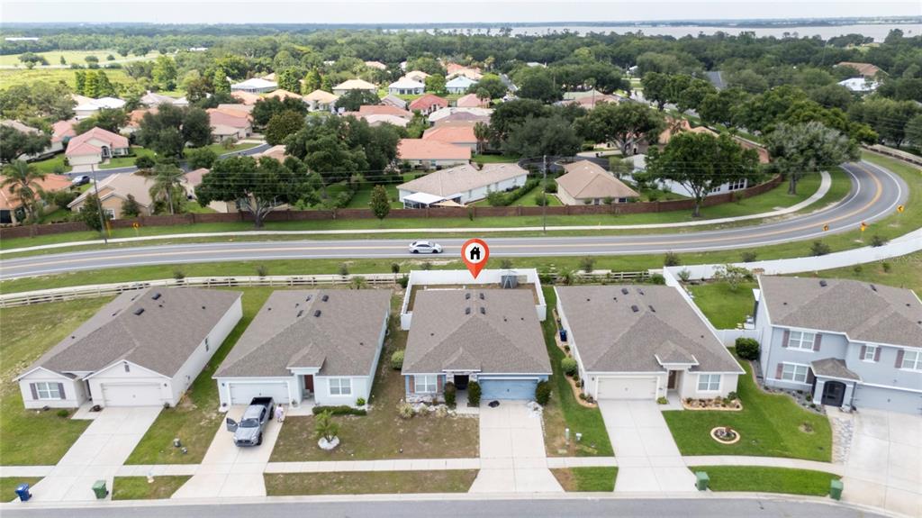 An aerial view shows a row of suburban houses with a red location pin — 3268 COUNTRY WALK CLUB CIRCLE, WINTER HAVEN, FL